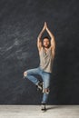 Happy handsome man making a yoga pose in studio Royalty Free Stock Photo