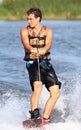 Happy handsome man wakesurfing