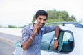 Happy handsome man young entrepreneur talking on mobile phone standing by his new car Royalty Free Stock Photo