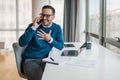 Happy handsome millennial businessman making phone call to client, consulting customer Royalty Free Stock Photo