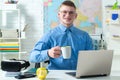 Happy handsome student in spectacles having an exelent mark for exam. Portrait of happy male student works on laptop Royalty Free Stock Photo