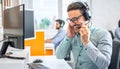 Happy handsome technical support operator with headset working in call center Royalty Free Stock Photo