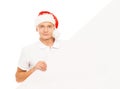 Happy and handsome teenage guy in a Christmas hat and a banner Royalty Free Stock Photo