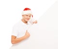 Happy and handsome teenage guy in a Christmas hat and a banner Royalty Free Stock Photo