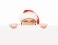 Happy and handsome teenage guy in a Christmas hat and a banner Royalty Free Stock Photo