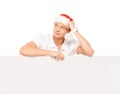 Happy and handsome teenage guy in a Christmas hat and a banner Royalty Free Stock Photo