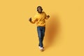 Happy handsome young african guy listening to music and dancing Royalty Free Stock Photo
