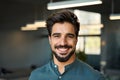 Happy handsome young business man looking at camera in office headshot portrait. Royalty Free Stock Photo