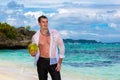 Happy handsome young male wearing in white shirt is standing on Royalty Free Stock Photo