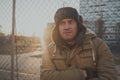 Happy handsome young man in cap with earflaps. The young man in the fur hat Royalty Free Stock Photo