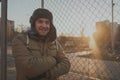 Happy handsome young man in cap with earflaps. The young man in the fur hat Royalty Free Stock Photo