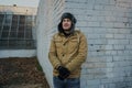 Happy handsome young man in cap with earflaps. The young man in the fur hat Royalty Free Stock Photo