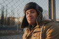 Happy handsome young man in cap with earflaps. The young man in the fur hat Royalty Free Stock Photo