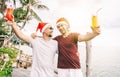 Happy handsome young men, gay family, celebrates New Year and Christmas at a tropical resort, LGBT values, equal rights for