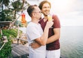 Happy handsome young men, gay family in a tropical resort with fruit necks, LGBT values, equal rights for everyone. Vacations and