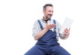 Happy handyman wathcing something funny on tablet Royalty Free Stock Photo