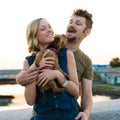 Happy hansome young couple with small dog