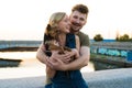 Happy hansome young couple with small dog