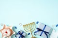 Happy Hanukkah banner template. Flat lay gold menorah, jelly donut, candles, gift boxes on pastel blue background. Jewish holiday Royalty Free Stock Photo