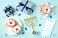 Happy Hanukkah elements on pastel blue background. Flat lay, top view Royalty Free Stock Photo