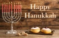 Happy Hanukkah. Silver menorah, sufganiyot and dreidels on wooden background Royalty Free Stock Photo