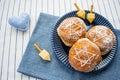 Happy Hanukkah. A traditional treat of doughnuts with David star and dreidel made from cheese and biscuit sticks. Blue fabric