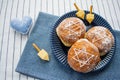 Happy Hanukkah. A traditional treat of doughnuts with David star and dreidel made from cheese and biscuit sticks. Blue fabric