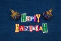 HAPPY HANUKKAH word text collage with colorful dreidels, multi colored fabric on blue denim, Jewish holiday Royalty Free Stock Photo