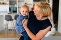 Happy family indoors. Portrait of beautiful mother with cute baby playing smiling together. Royalty Free Stock Photo