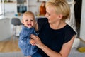 Happy family indoors. Portrait of beautiful mother with cute baby playing smiling together. Royalty Free Stock Photo