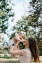 happy harmonious family outdoors. mother throws baby up, laughing and playing in the summer on the nature Royalty Free Stock Photo