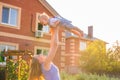 Happy harmonious family outdoors. mother throws baby up, laughing and playing in the summer on the nature. Royalty Free Stock Photo