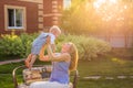 Happy harmonious family outdoors. mother throws baby up, laughing and playing in the summer on the nature. Royalty Free Stock Photo