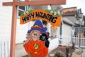 Happy Haunting halloween themed sign in front of home in street in small town USA