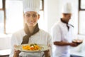 Happy head chef presenting her food Royalty Free Stock Photo