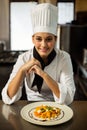 Happy head chef presenting her food Royalty Free Stock Photo