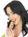 Happy Healthy Attractive Young Woman Eating a Breakfast Cereal Bar Royalty Free Stock Photo