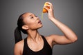 Happy healthy black asian woman squeezing orange juice fruit Royalty Free Stock Photo