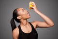 Happy healthy black asian woman squeezing orange juice fruit