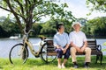 Happy and healthy couple Asian sitting chair beside a bicycle Family and friendship lifestyle, Enjoyment of active seniors, and