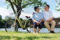 Happy and healthy couple Asian sitting chair beside a bicycle Family and friendship lifestyle, Enjoyment of active seniors, and Royalty Free Stock Photo