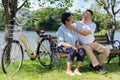 Happy and healthy couple Asian sitting chair beside a bicycle Family and friendship lifestyle, Enjoyment of active seniors, and