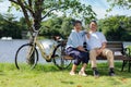 Happy and healthy couple Asian sitting chair beside a bicycle Family and friendship lifestyle, Enjoyment of active seniors, and Royalty Free Stock Photo