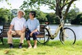 Happy and healthy couple Asian sitting chair beside a bicycle Family and friendship lifestyle, Enjoyment of active seniors, and