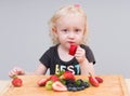 Happy kid  eating fresh strawberries Royalty Free Stock Photo