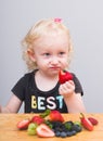 Happy kid  eating fresh strawberries Royalty Free Stock Photo