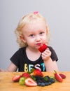 Happy kid  eating fresh strawberries Royalty Free Stock Photo