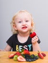 Happy kid  eating fresh strawberries Royalty Free Stock Photo