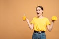 Happy healthy lifestyle portrait of smiling sporty woman holding vitamin set with orange juice and fruit in her hands Royalty Free Stock Photo