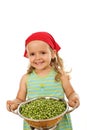 Happy healthy little girl with fresh peas Royalty Free Stock Photo